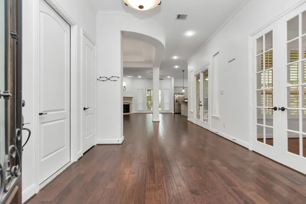 a view of a hallway with wooden floor