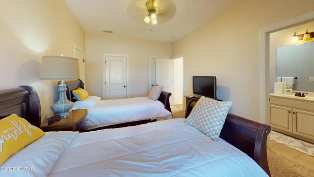 a bedroom with two beds and a chandelier