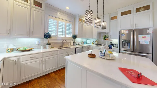 a kitchen with a sink a stove a refrigerator and cabinets