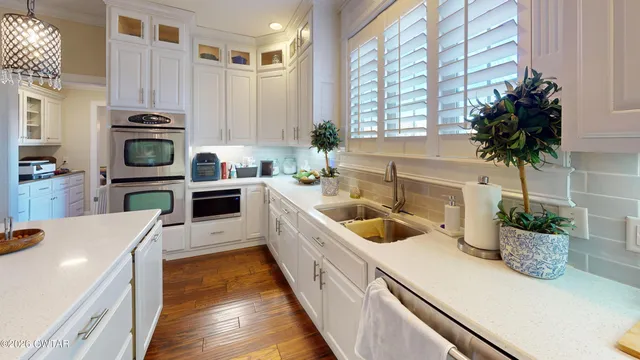 a kitchen with a sink a stove and cabinets