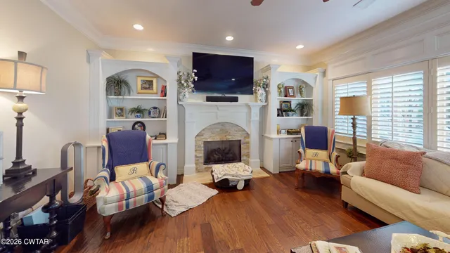 a living room with furniture fireplace and flat screen tv