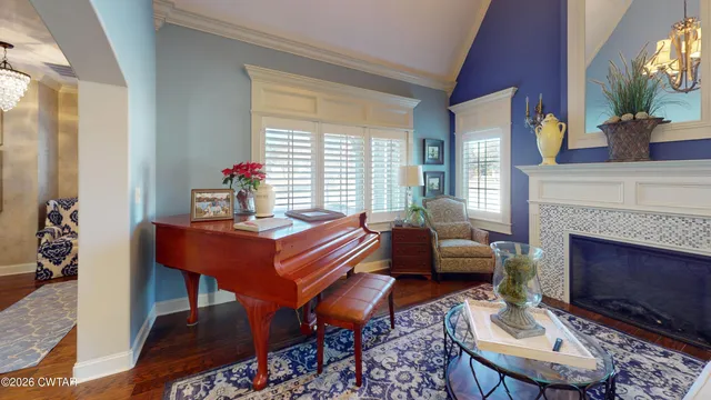 a living room with furniture a fireplace and next to windows