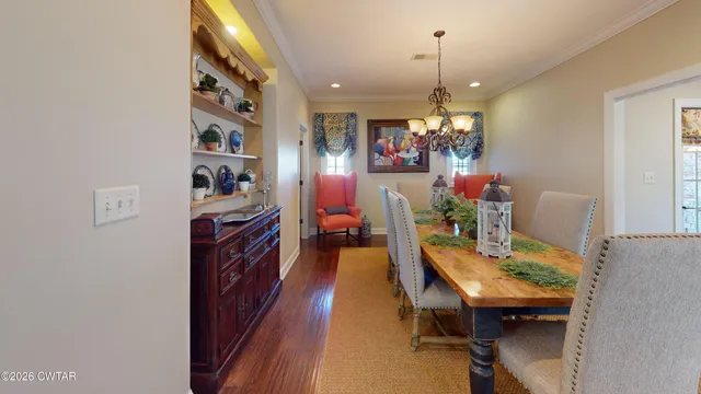 a view of a dining room with furniture and a chandelier