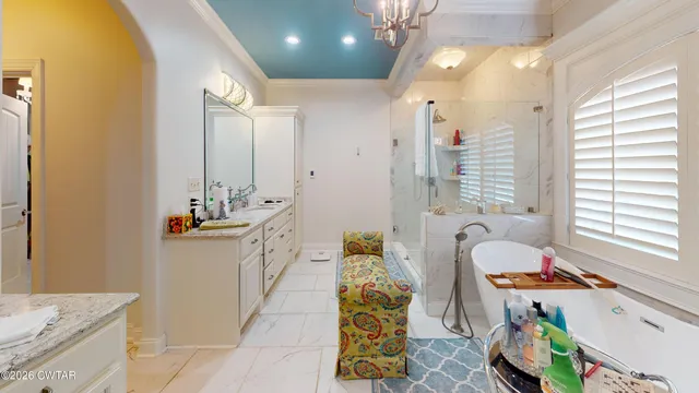 a bathroom with a sink mirror vanity and bathtub