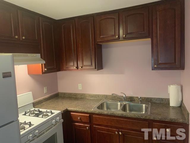 408 Lansing Street Raleigh, NC 27610 - Photo 2 of 11 a kitchen with granite countertop stainless steel appliances wooden cabinets and a sink