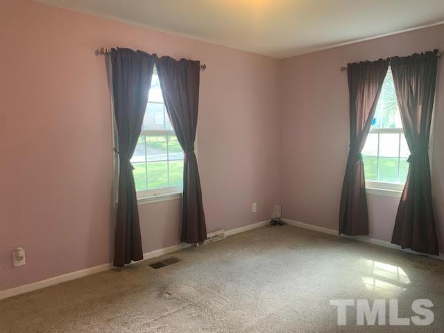 408 Lansing Street Raleigh, NC 27610 - Photo 3 of 11 an empty room with wooden floor and windows