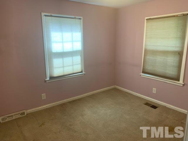 408 Lansing Street Raleigh, NC 27610 - Photo 4 of 11 an empty room with a window