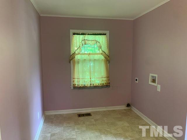 408 Lansing Street Raleigh, NC 27610 - Photo 6 of 11 a view of an empty room with a window