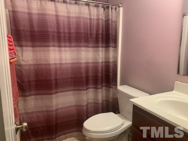 408 Lansing Street Raleigh, NC 27610 - Photo 7 of 11 a white toilet sitting next to a shower