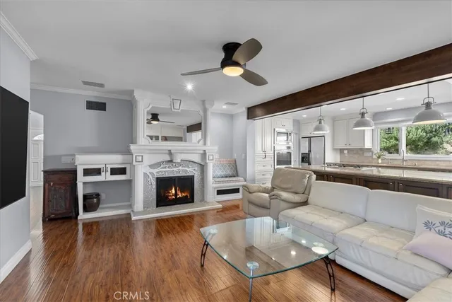 a living room with furniture fireplace and wooden floor