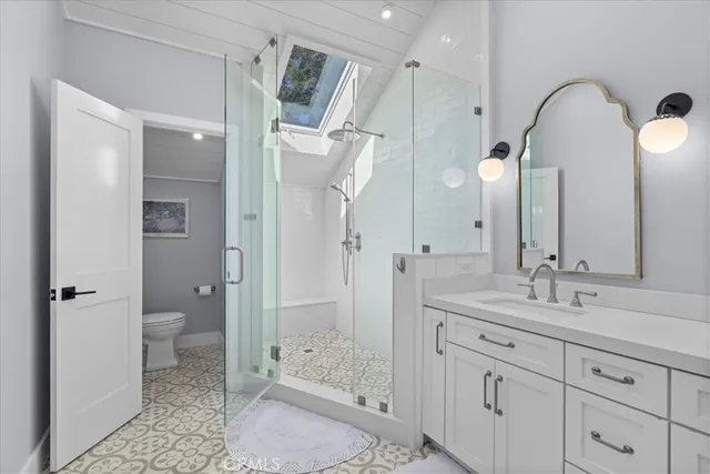 a spacious bathroom with a double vanity sink toilet and shower