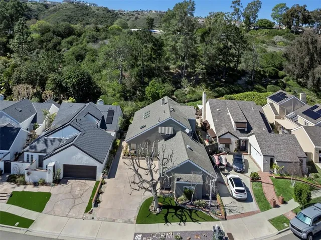 an aerial view of multiple houses with a yard