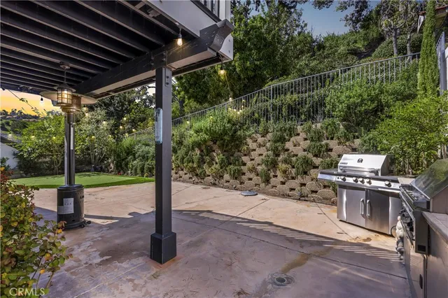 a view of a patio with table and chairs with wooden floor and fence