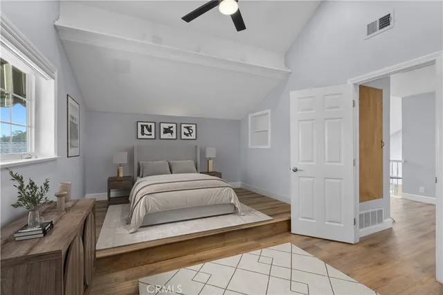 a spacious bedroom with a bed and ceiling fan