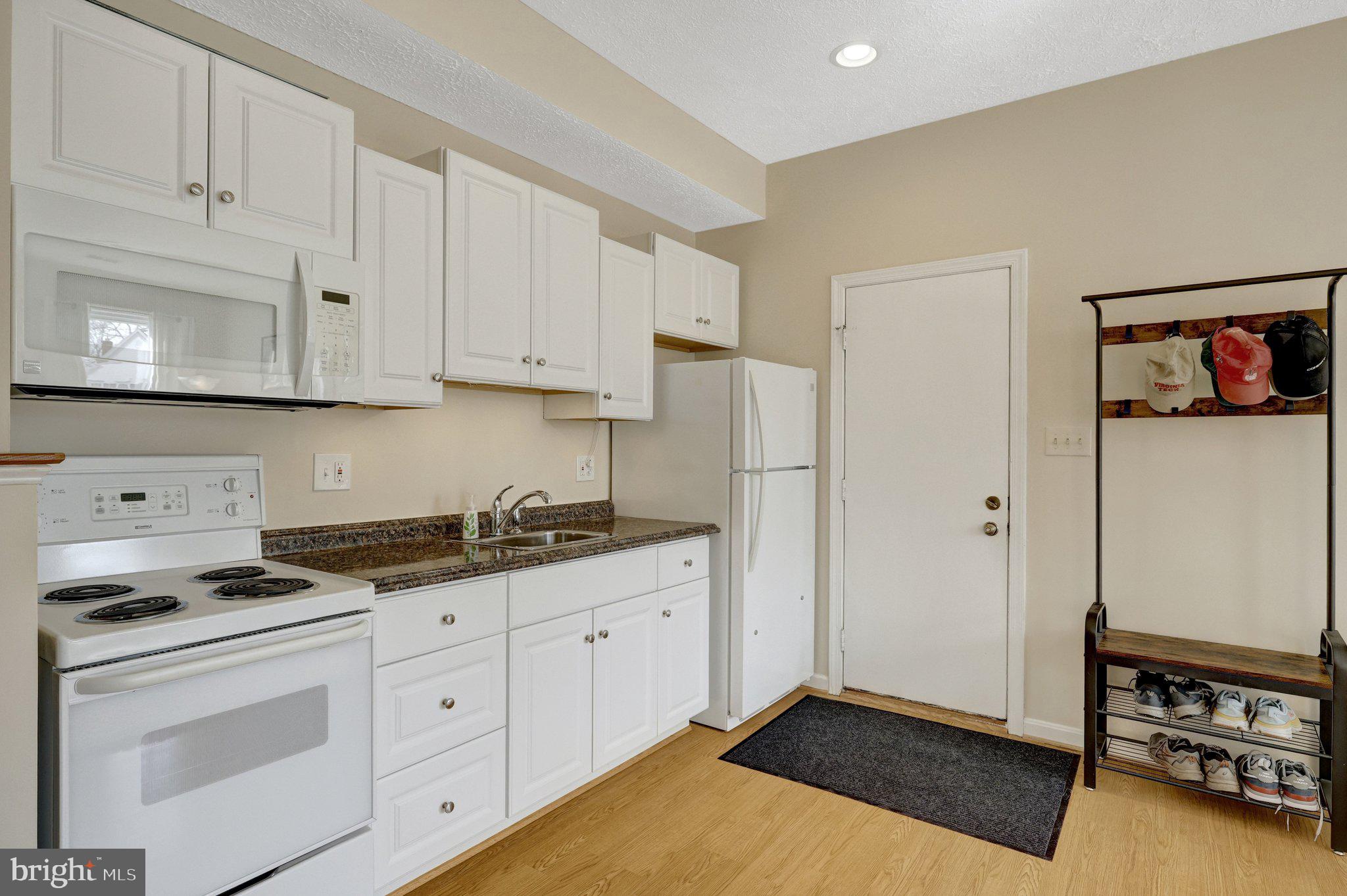 34 Lipscomb Court Sterling, VA 20165 - Photo 31 of 91 a kitchen with stainless steel appliances granite countertop a stove a sink and a refrigerator with white cabinets