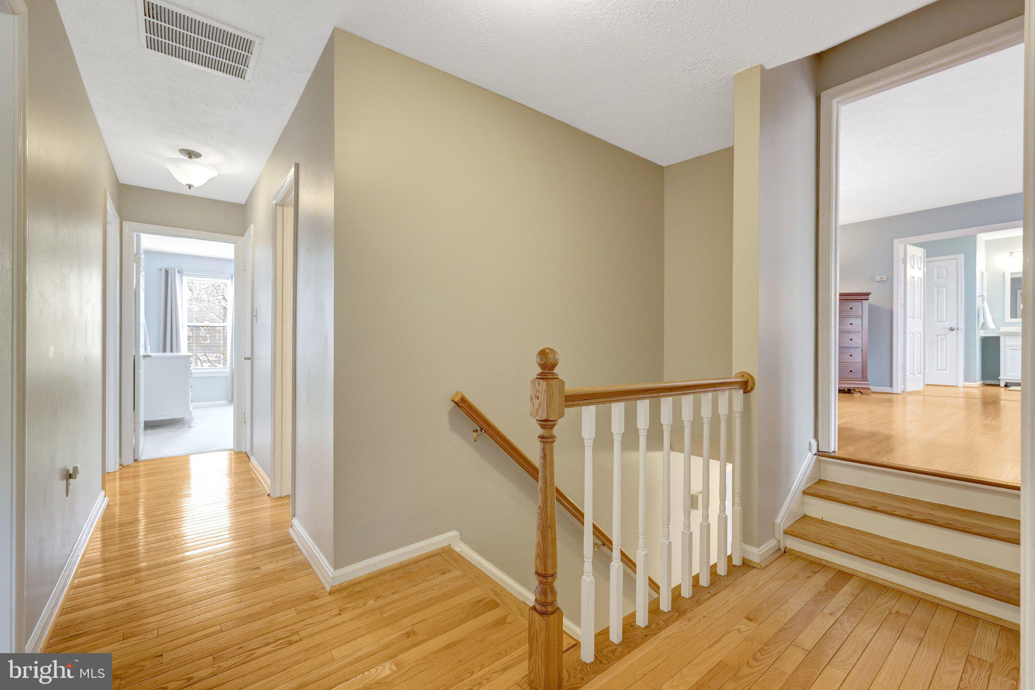 34 Lipscomb Court Sterling, VA 20165 - Photo 38 of 91 a view of a hallway with wooden floor and staircase