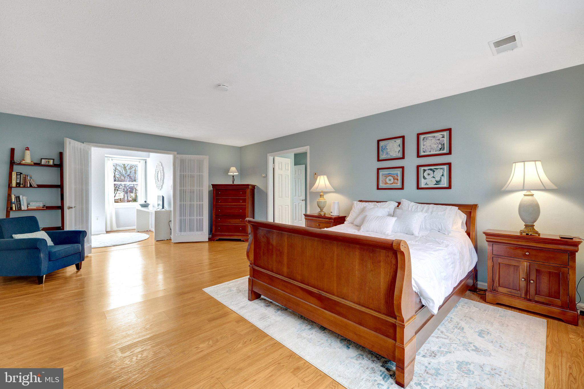 34 Lipscomb Court Sterling, VA 20165 - Photo 41 of 91 a spacious bedroom with a bed a table and bookshelf