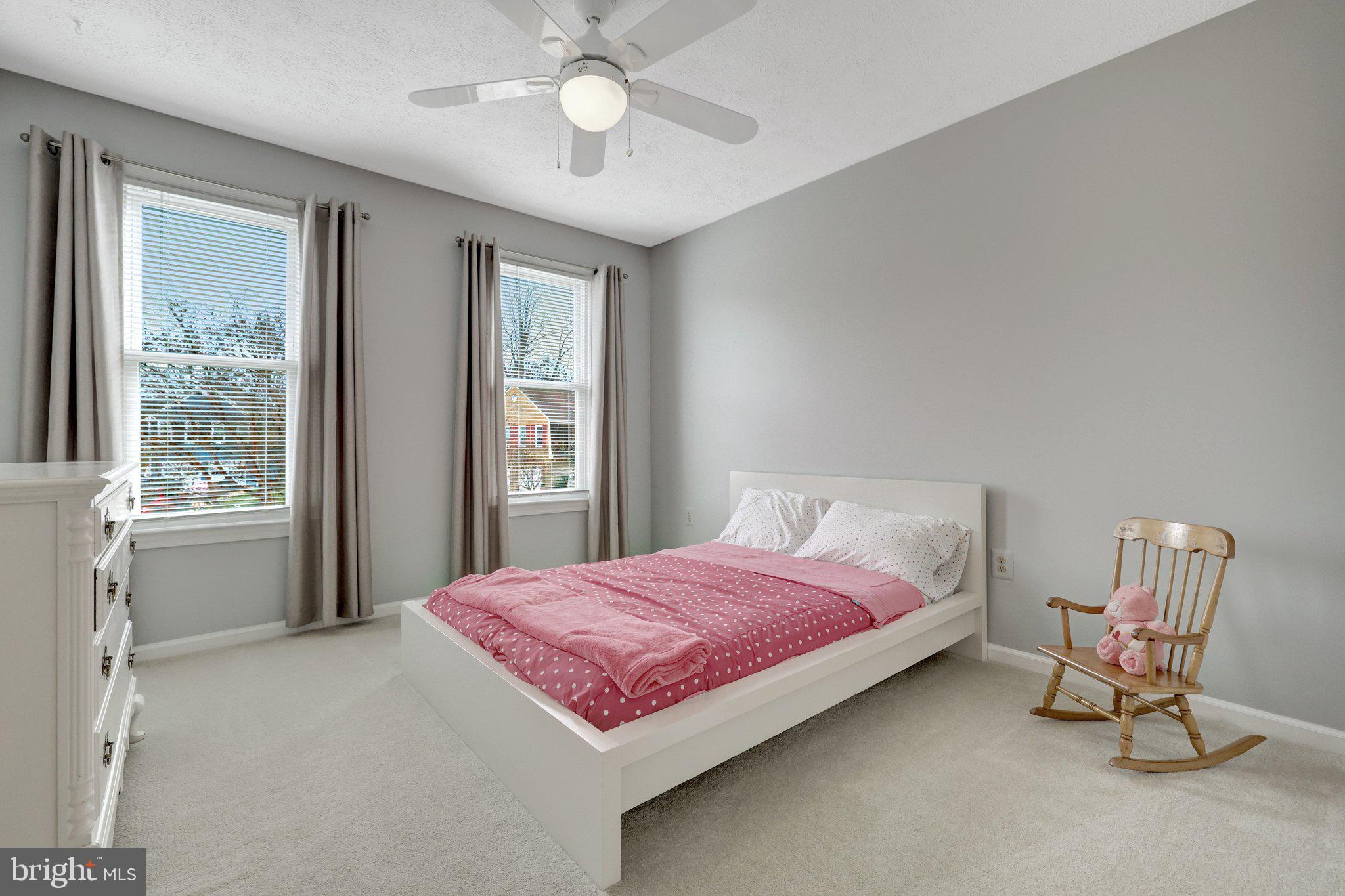 34 Lipscomb Court Sterling, VA 20165 - Photo 53 of 91 a spacious bedroom with a bed and chair