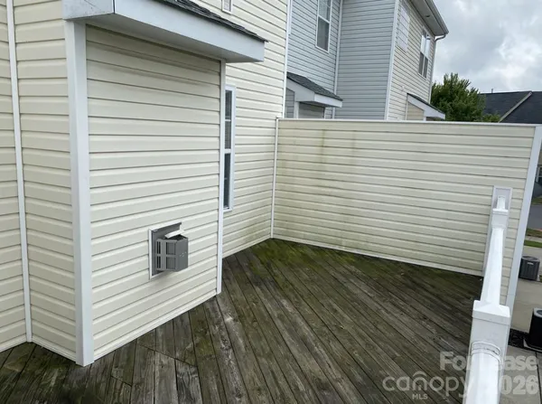 a view of a brick house with a small yard