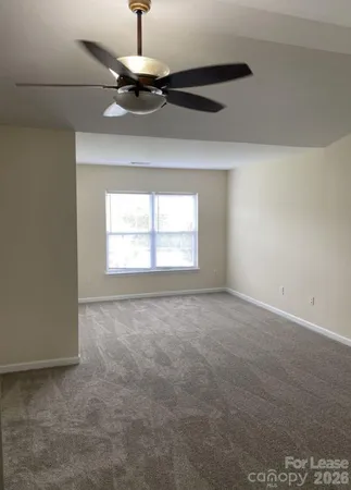 a view of empty room with a ceiling fan