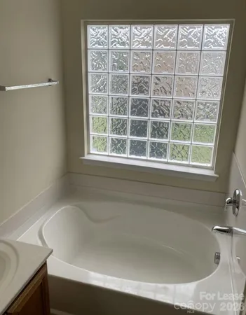 a bathroom with a glass shower door