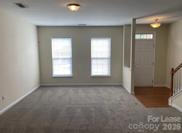 an empty room with windows and closet