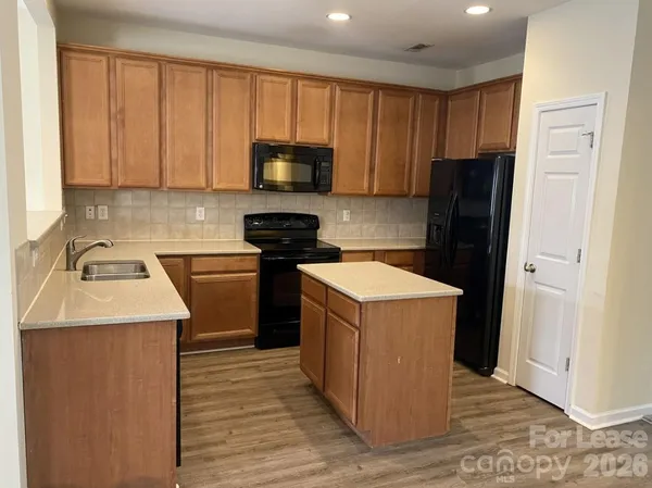 a kitchen with a sink stove and refrigerator