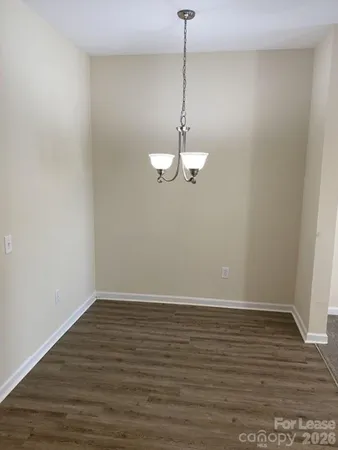 a view of a room with wooden floor and white walls