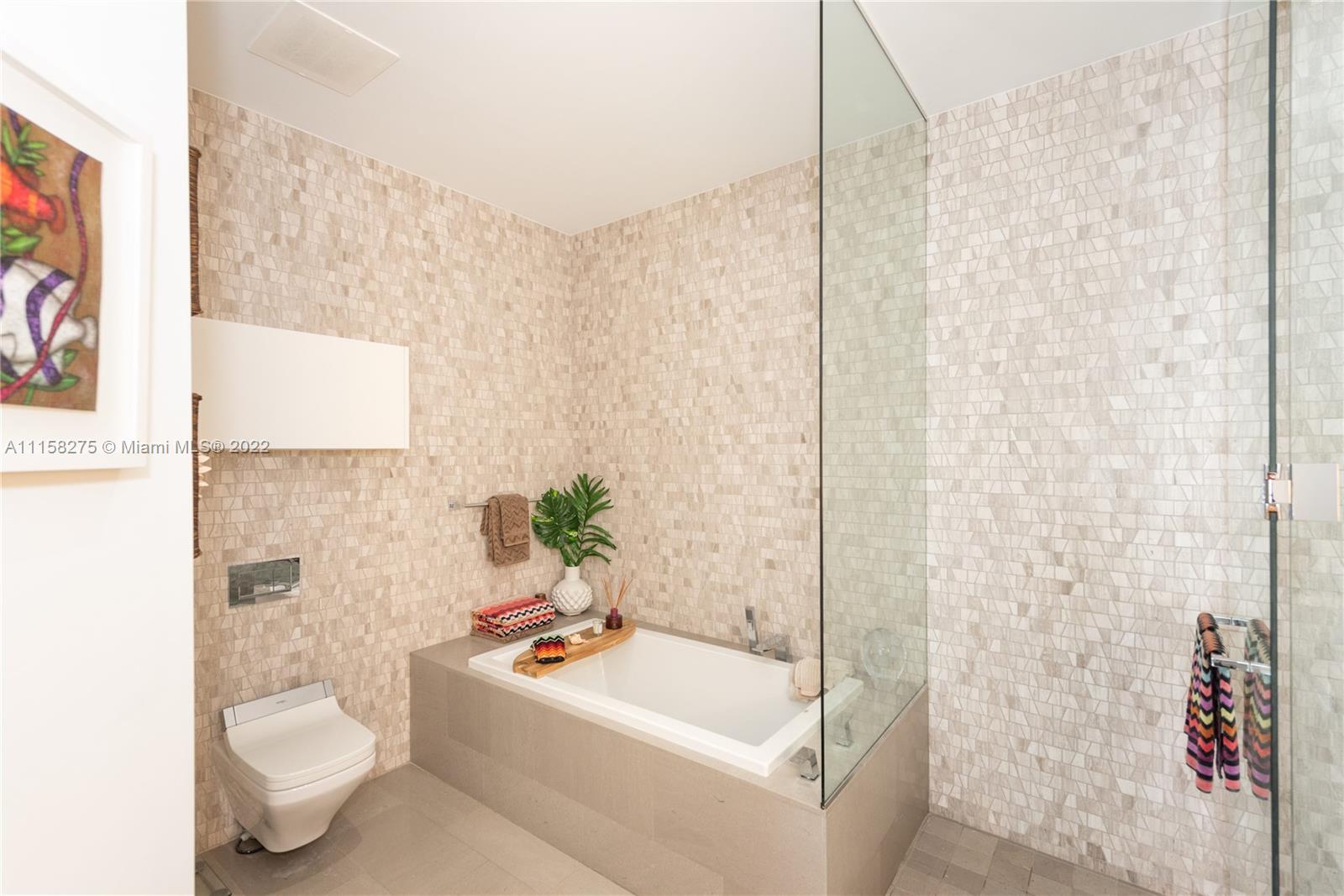 88 Southwest 7th Street, Unit 4110 Miami, FL 33130 - Photo 13 of 33 a bathroom with a sink a toilet and shower