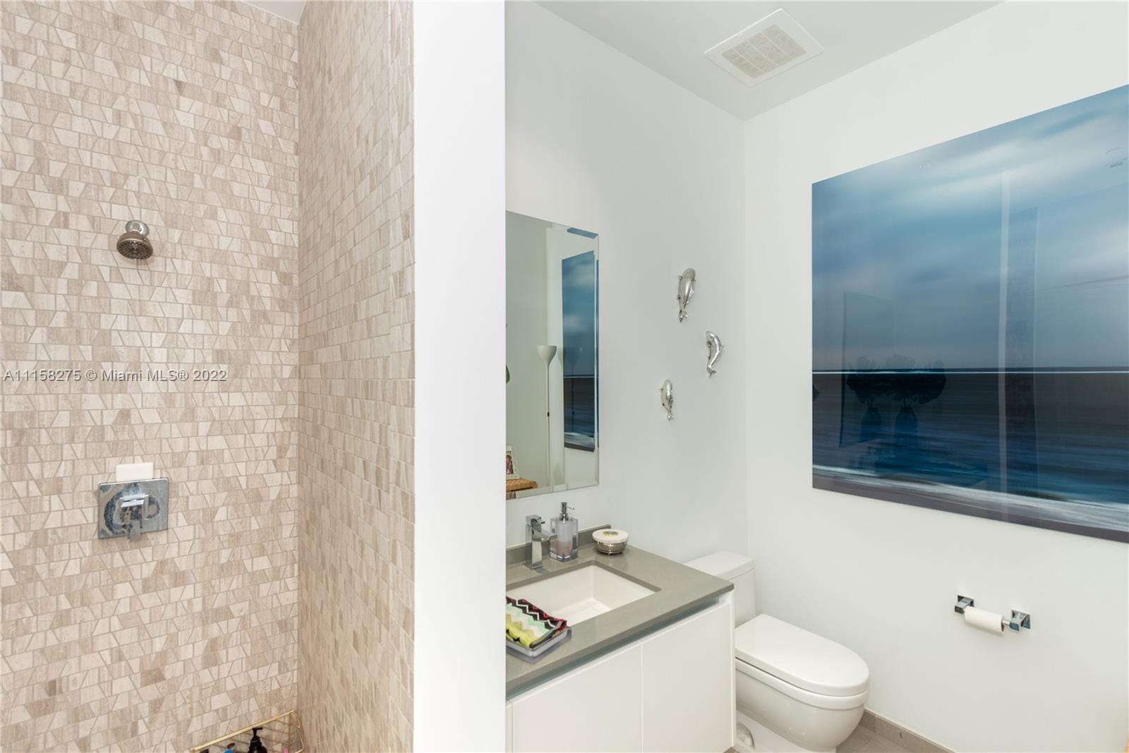 88 Southwest 7th Street, Unit 4110 Miami, FL 33130 - Photo 16 of 33 a bathroom with a sink a toilet and shower