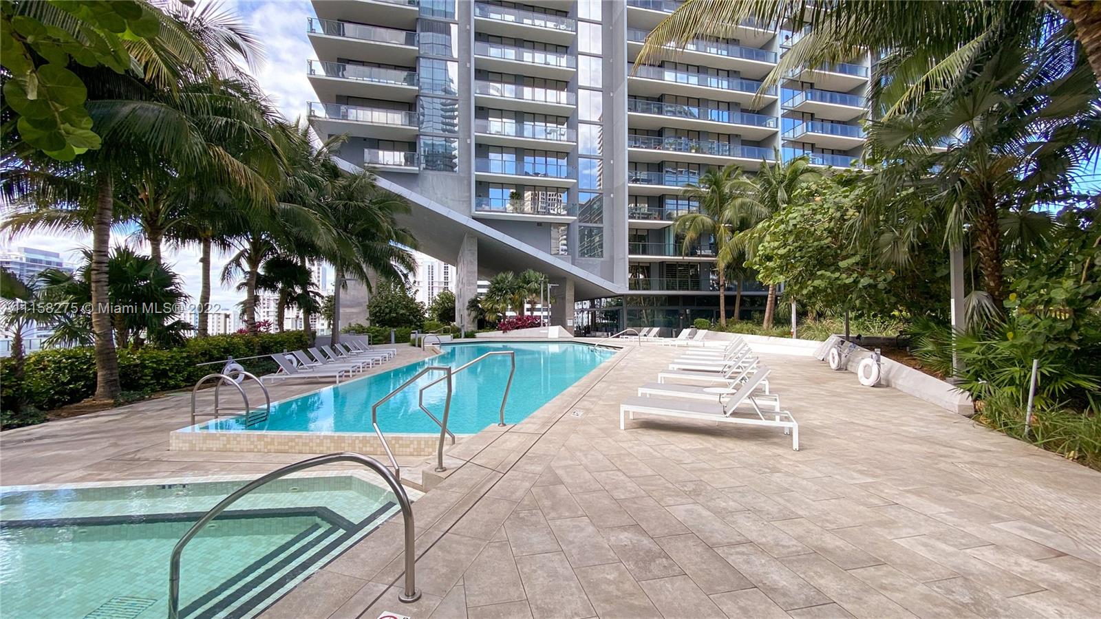 88 Southwest 7th Street, Unit 4110 Miami, FL 33130 - Photo 20 of 33 a view of a swimming pool with a lounge chairs
