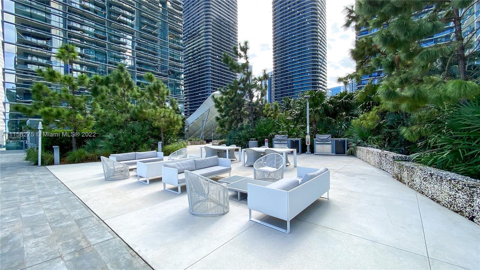 88 Southwest 7th Street, Unit 4110 Miami, FL 33130 - Photo 22 of 33 a view of a patio with couches and potted plants