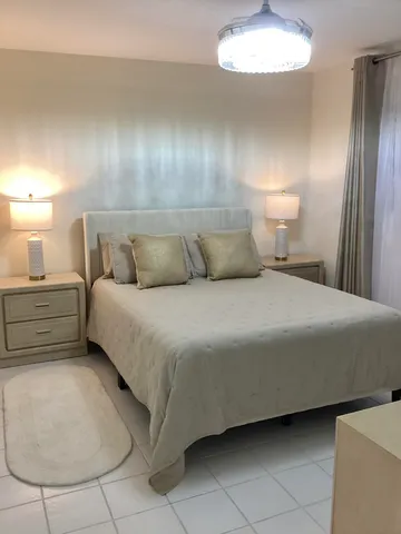 a bed room with a bed and a night stand