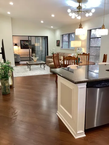 a kitchen with kitchen island granite countertop a stove and a refrigerator