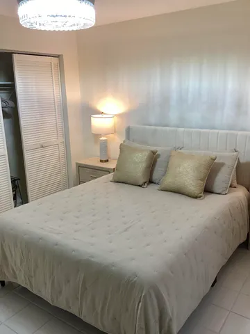 a bedroom with a bed and a walk in closet