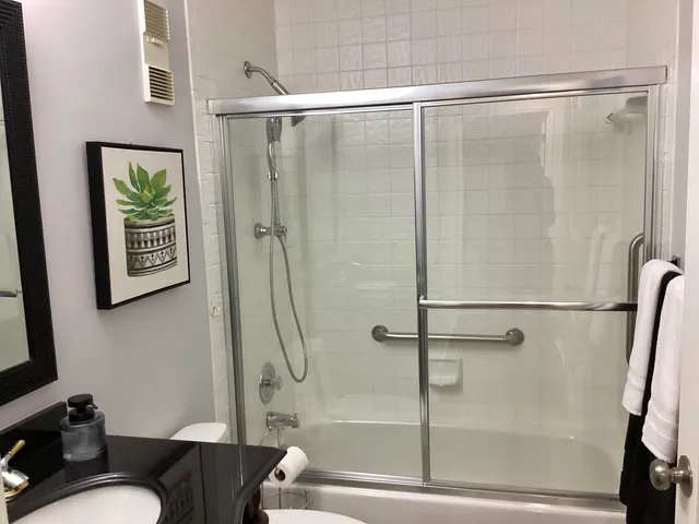 a bathroom with a shower and a toilet