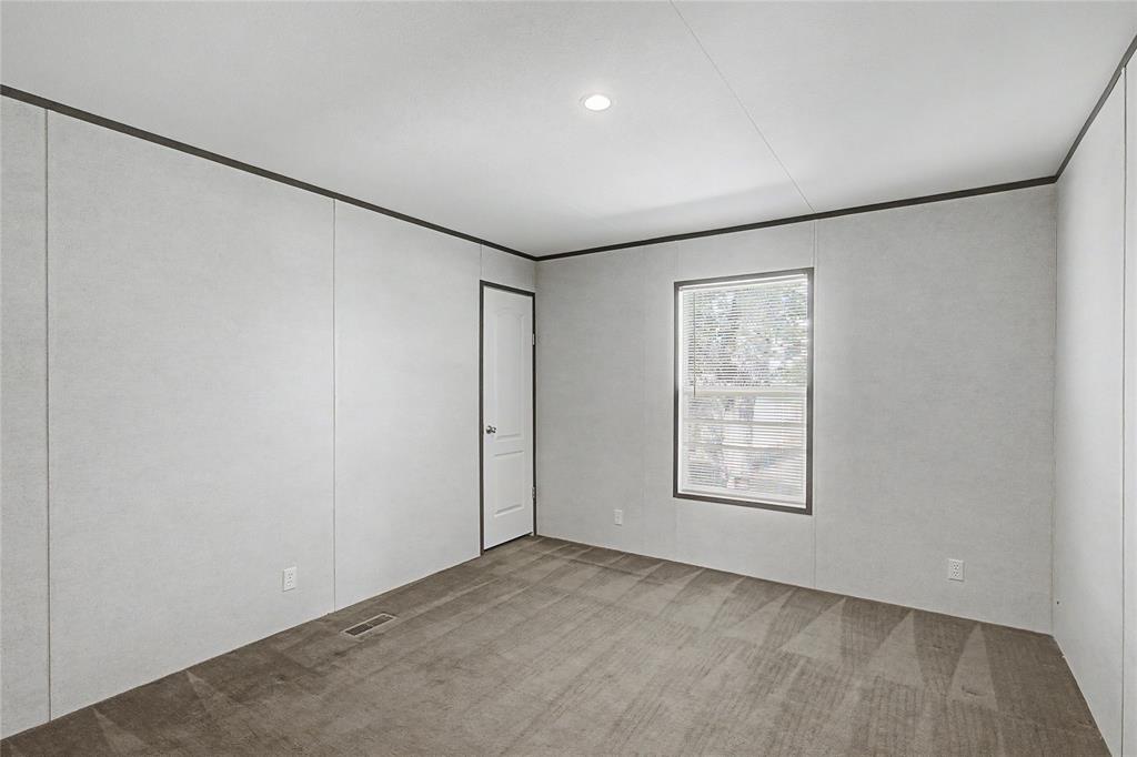 177 New Highland Road Springtown, TX 76082 - Photo 25 of 40 Interior room with light gray panel walls and coordinating trim