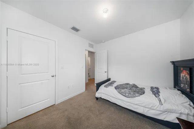 a bedroom with a bed and a tv on table