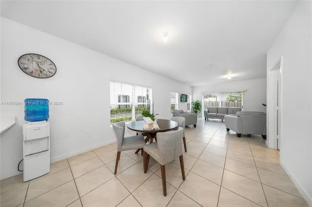a living room with furniture a clock and a window