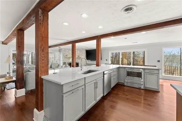 a spacious bathroom with a double vanity sink a mirror and a bathtub