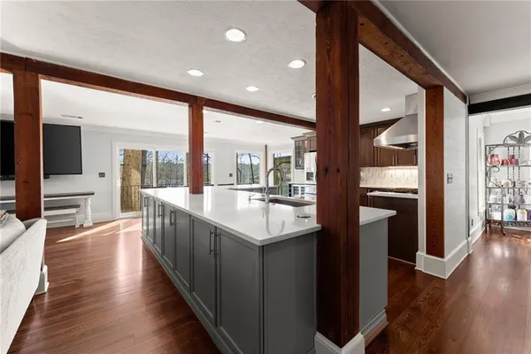 a bedroom with a large bed and wooden floor