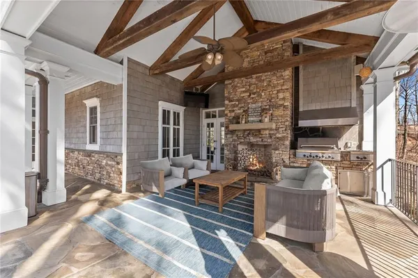 a view of a patio with table and chairs under an umbrella