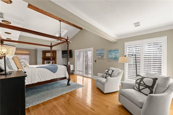 a view of a patio with couches table and chairs and wooden floor
