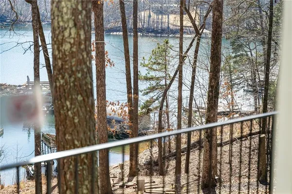 a view of patio with chairs and tables under an umbrella