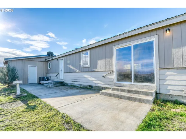 a view of a big yard with a building in the background