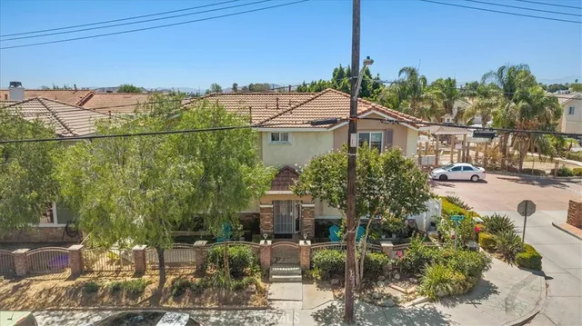 a white house that has tree in front of it