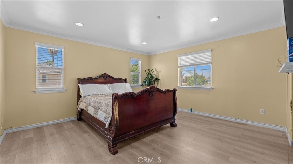 10115 Onyx Way Riverside, CA 92503 - Photo 7 of 18 a spacious bedroom with a bed and wooden floor