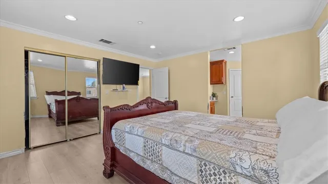 a bedroom with a bed and a flat screen tv