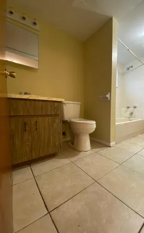 a kitchen with a refrigerator sink and cabinets