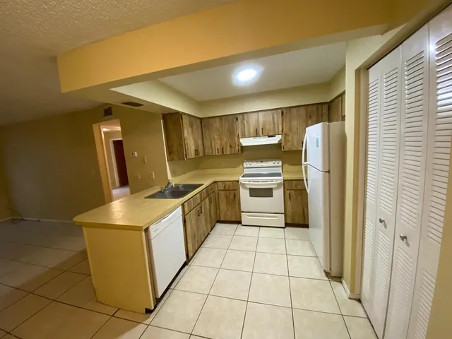 a view of room with walk in closet and wooden floor